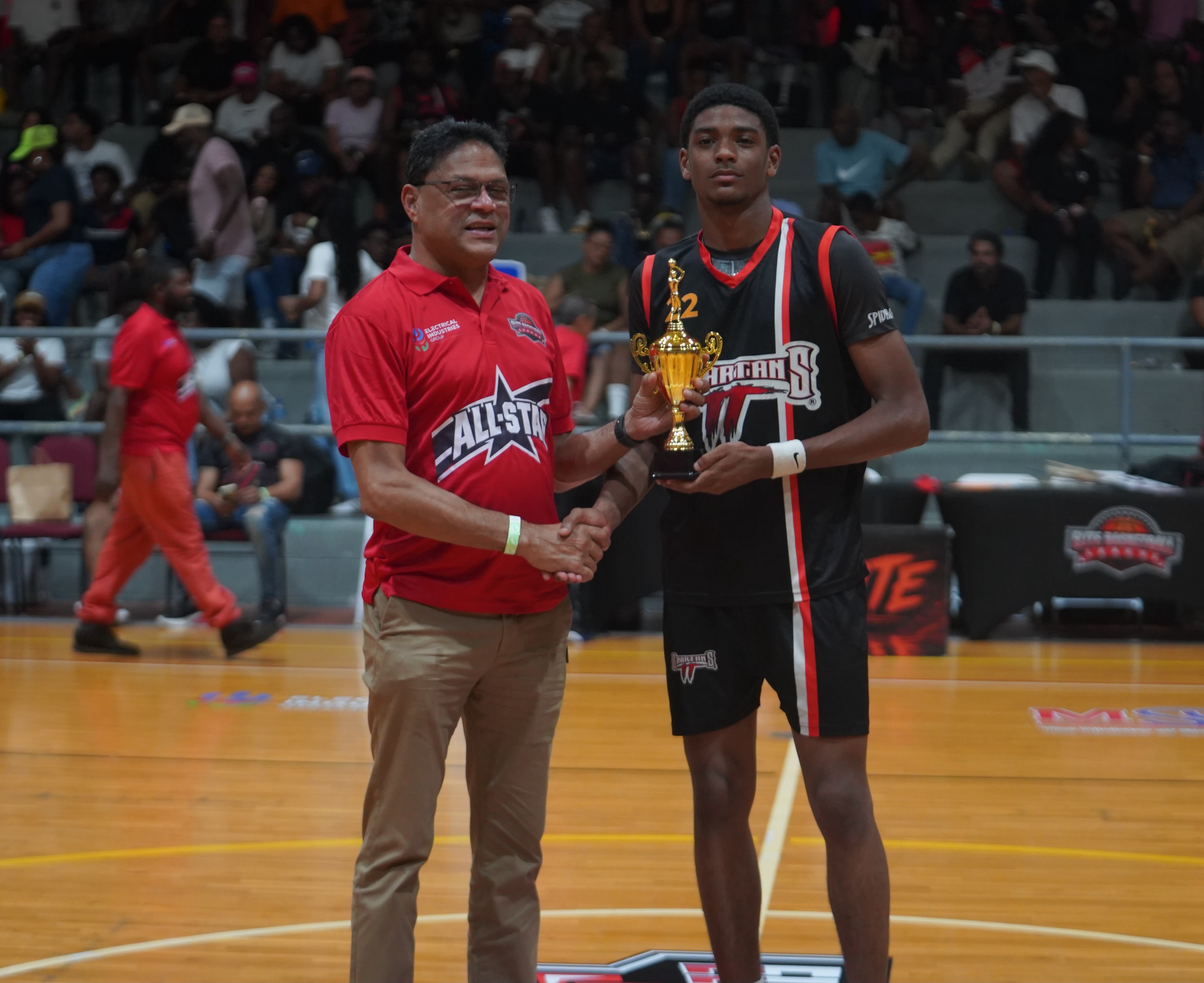 Minister of Justice Devesh Maharaj (left) presents William Francis with his EBL All-Star dunk contest trophy.