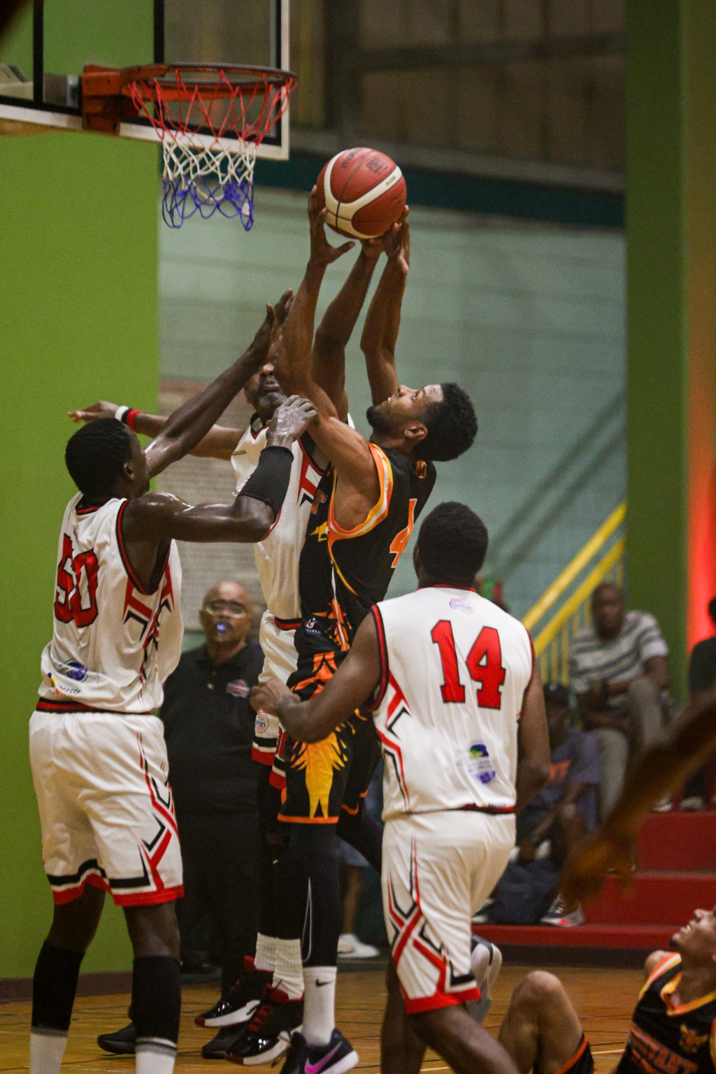 Morvant Oilbirds player attacking the basket against defenders