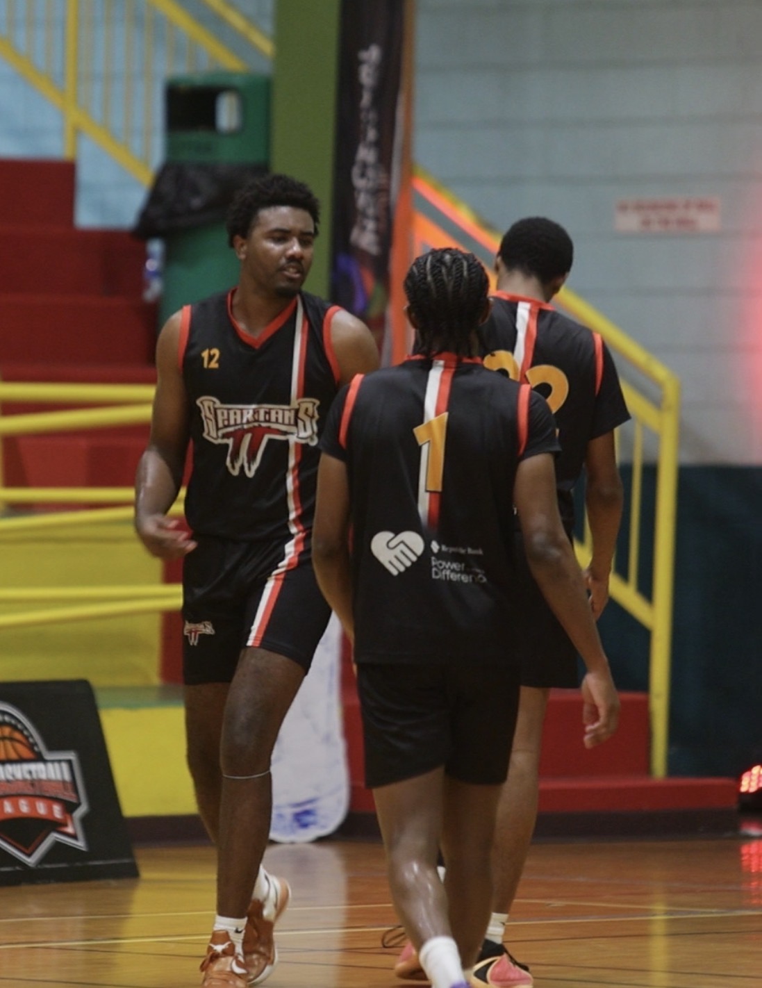 Spartans TT players celebrate Freedom Leon’s three-point play.
